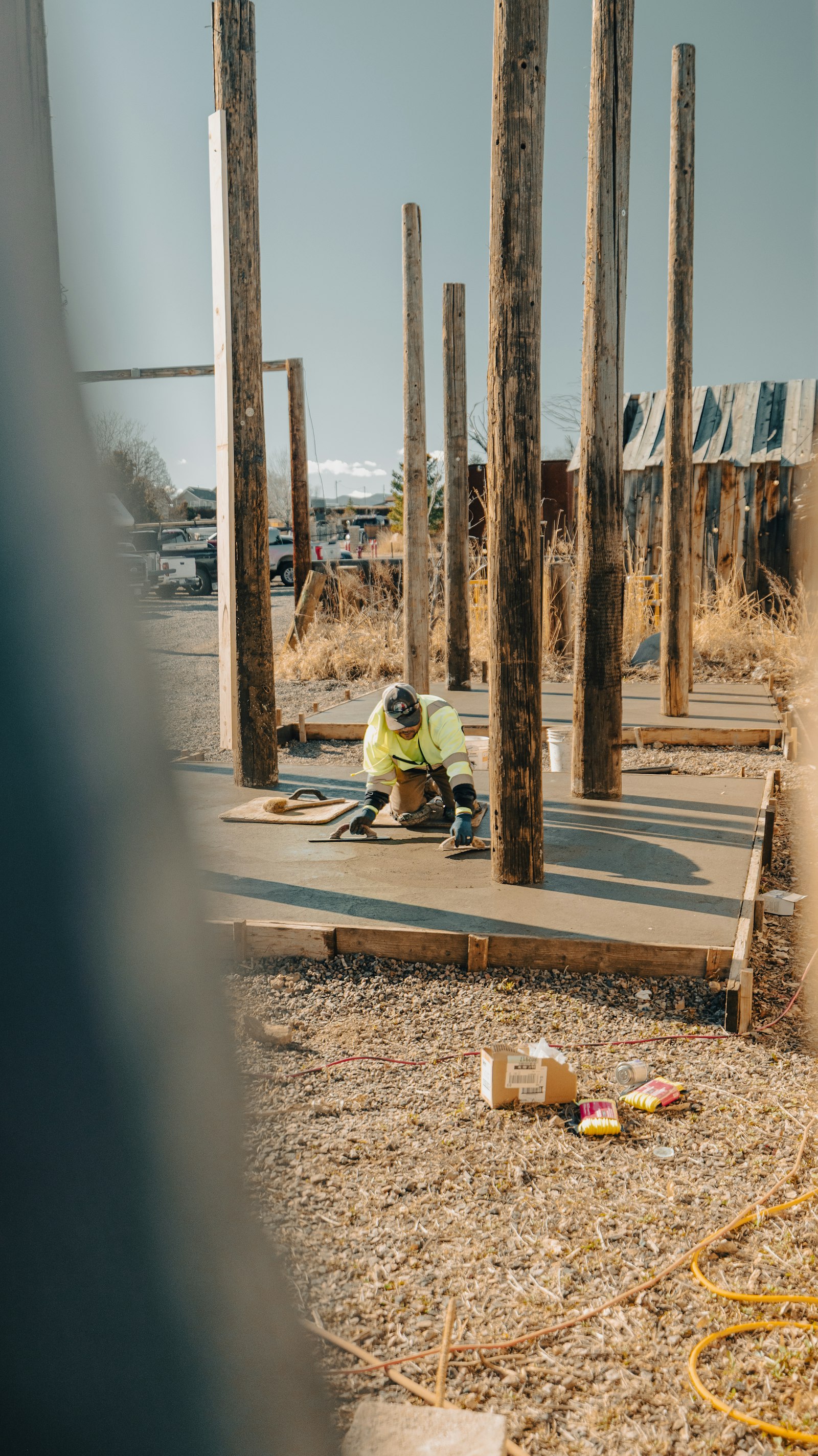 Worker finishing a newly poured concrete slab